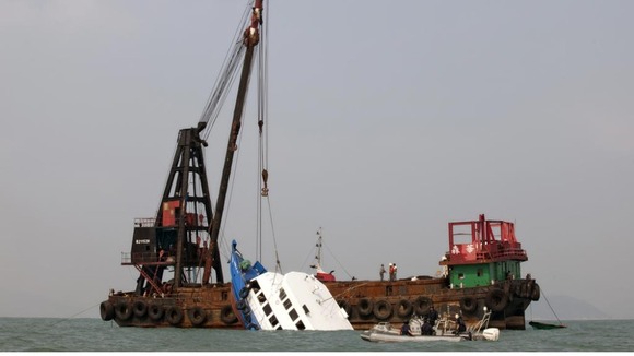 The sunken ferry is lifted out of the water off Hong Kong on October 2