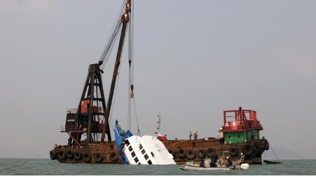 The sunken ferry is lifted out of the water off Hong Kong on October 2