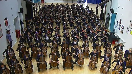 Students rehearse together in the school hall.