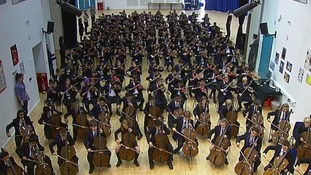 Students rehearse together in the school hall.