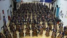 Students rehearse together in the school hall.