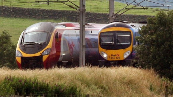 Virgin train passes a First Group train on the West Coast Main Line