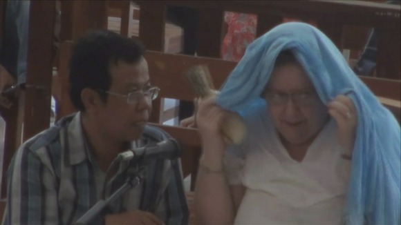 Sandiford tried to cover her head to hide from cameras