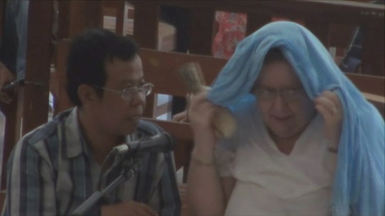 Sandiford tried to cover her head to hide from cameras
