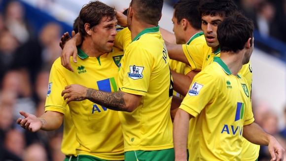 Grant Holt celebrates scoring the opener at Stamford Bridge