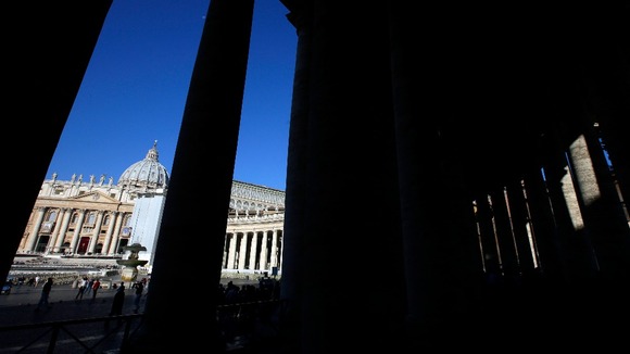 Saint Peter's Basilica is seen through the columnade at the Vatican