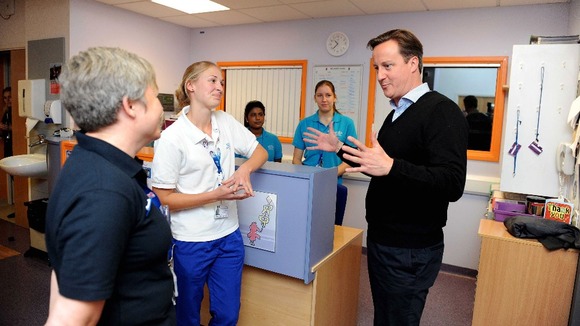 Prime Minister David Cameron chats to nurses during a visit to the John Radcliffe Childrens Hospital in Oxford on Saturday.
