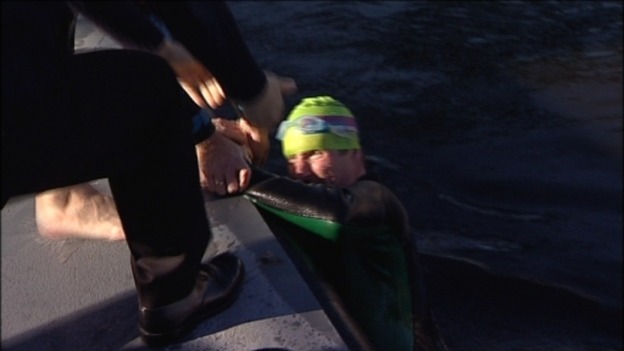 Henry is helped out of the cold water