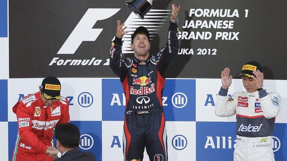 Red Bull driver Sebastian Vettel of Germany, center, celebrates on the podium after winning the Japanese Formula One Grand Prix,