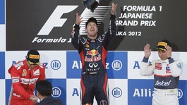 Red Bull driver Sebastian Vettel of Germany, center, celebrates on the podium after winning the Japanese Formula One Grand Prix,