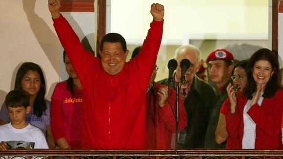 Venezuelan President Hugo Chavez celebrates from people's balcony at Miraflores Palace in Caracas