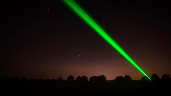 One of the laser lights cuts through the night sky