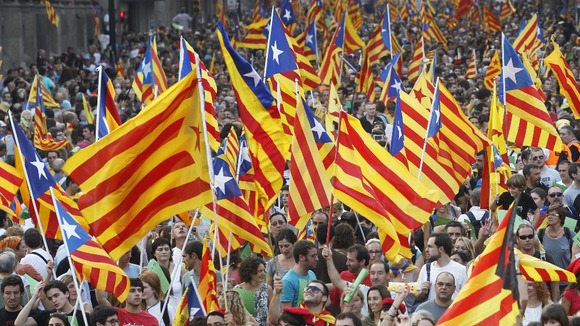 Demonstrators wave Catalonian flags on Catalan National Day in Barcelona