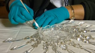 Staff cleaning pieces of chandelier