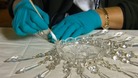 Staff cleaning pieces of chandelier