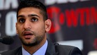 Bolton boxer Amir Khan has vowed to win back his world titles in 2013 at a press conference in London