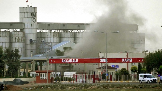 Smoke rises after a shell fired from Syria lands on the Turkish-Syrian border on October 7
