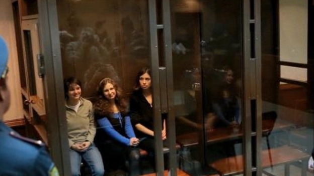 Maria Alekhina, Yekaterina Samutsevich and Nadezhda Tolokonnikova in a glass cage in a court room in Moscow