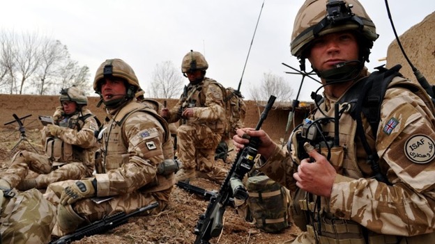 ‘Contact, wait out,’ Major Ed Hill (front right) radioing details of a firefight with insurgents back to headquarters.