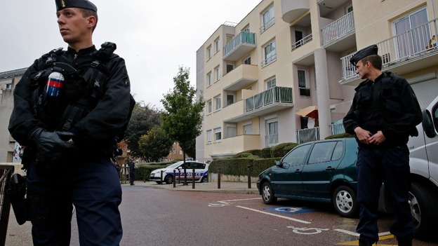 French police secure a garage in Torcy near Paris where the raid was carried out