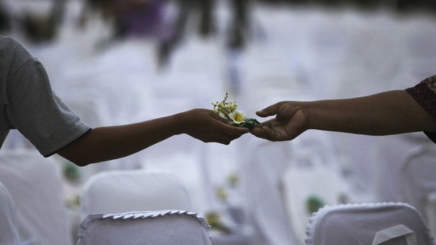 Flower exchanged between friends during a commemoration service for the 10th anniversary of the Bali bombing
