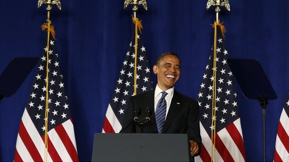 President Barack Obama smiles before he speaks at a campaign event in Miami