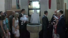 A congregation in church looking at a cardboard cut-out of a clergyman.