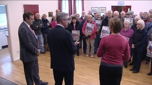 Stephen Hughes speaks to protestors