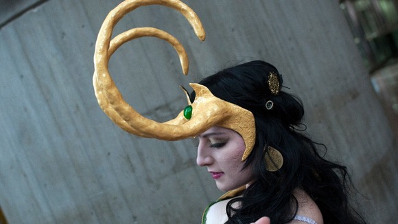 Dressed as the comic book character Loki, fan Alina Vukul, adjusts her costume during Comic Con at the Jacob Javitz Center