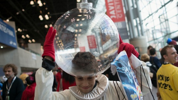 Fan Borges, dressed as Captain Olimar of the Pikmin video game series, adjust his helmet to his costume during Comic Con.