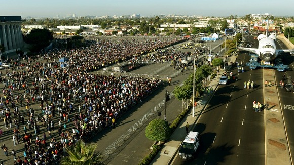 Spectators watch Endeavour as it stops in front of Los Angeles' Forum