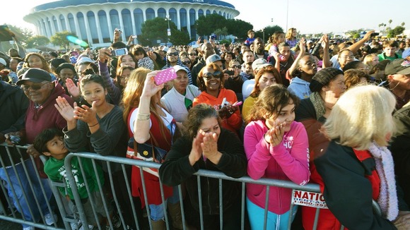 Crowds cheer the Endeavour as it passes the Forum