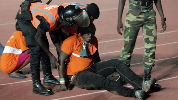 Security officials assist an injured fan.