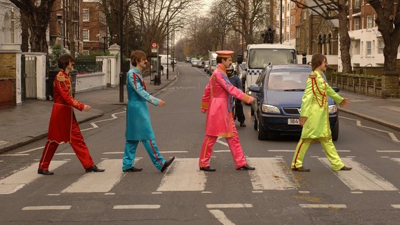 Beatles look-a-likes cross the famous zebra crossing in Abbey Road, St John's Wood.