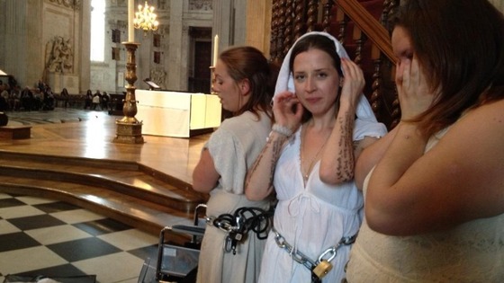 Four women chained themselves to the pulpit.