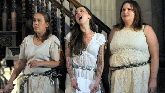 Female activists from the Occupy movement stage a protest by chaining themselves to the pulpit in St. Paul's Cathedral.
