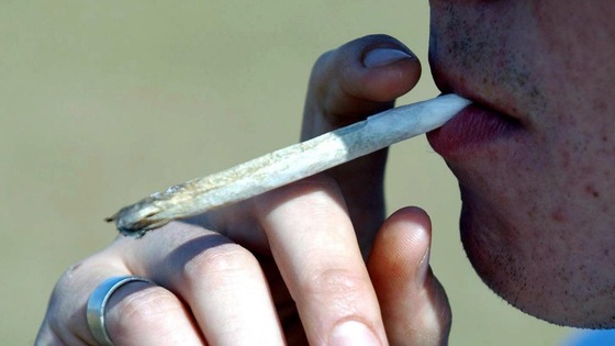 A man smoking a cannabis joint.
