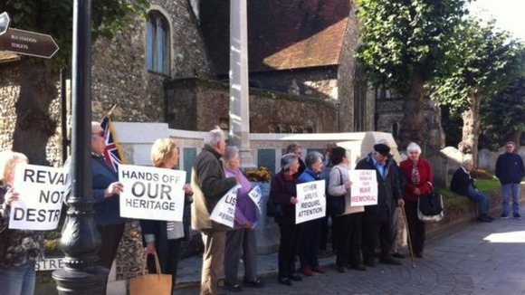 Campaigners demonstrate outside memorial