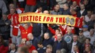 Fans hold a 'Justice for the 96' banner