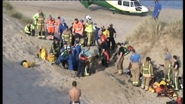 Emergency services try to hold back sand