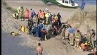 Emergency services try to hold back sand