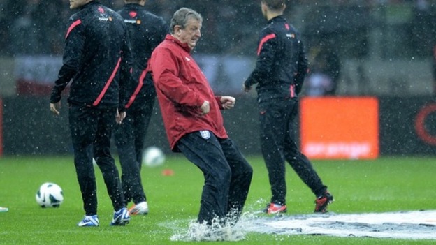 England boss Roy Hodgson tests the waterlogged pitch