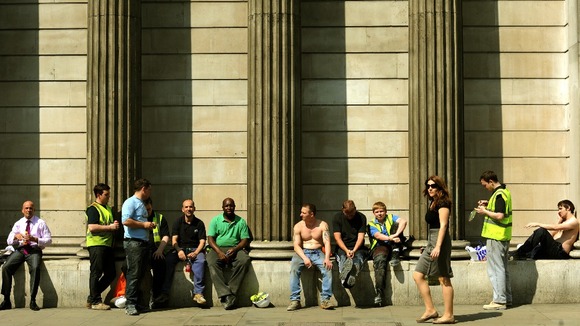 Workers enjoy the lunchtime sunshine outside the Bank of England, London.