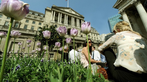 City workers enjoy the lunchtime sunshine outside the Bank of England, London.