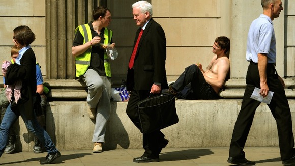 Workers enjoy the lunchtime sunshine outside the Bank of England, London.