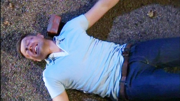 Carl King played by Tom Lister , lies on the floor after being hit with a brick by Chastity Dingle