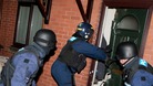Police officers smash into a North Manchester property during drugs raids.