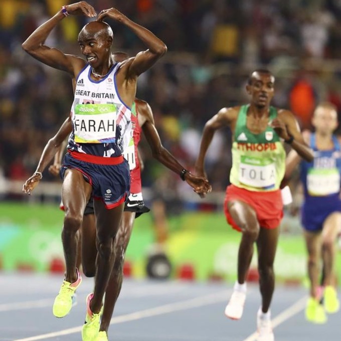 Mo Farah crosses the finish line in style.