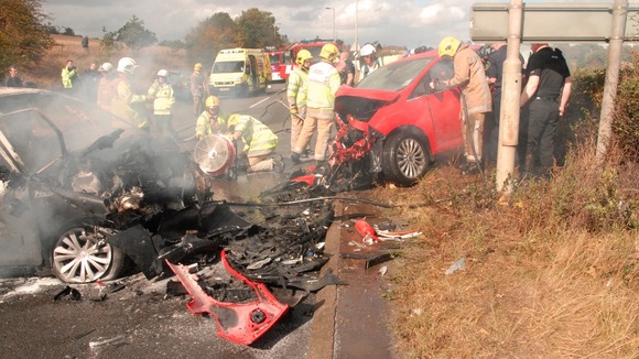 Two people were trapped inside the burning car