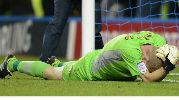 Sheffield Wednesday goalkeeper Chris Kirkland clutches his face after being shoved.